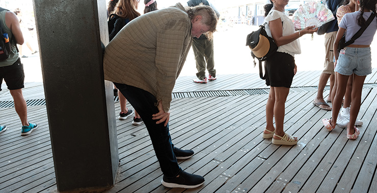 person bent over because they are very hot and can't cool off