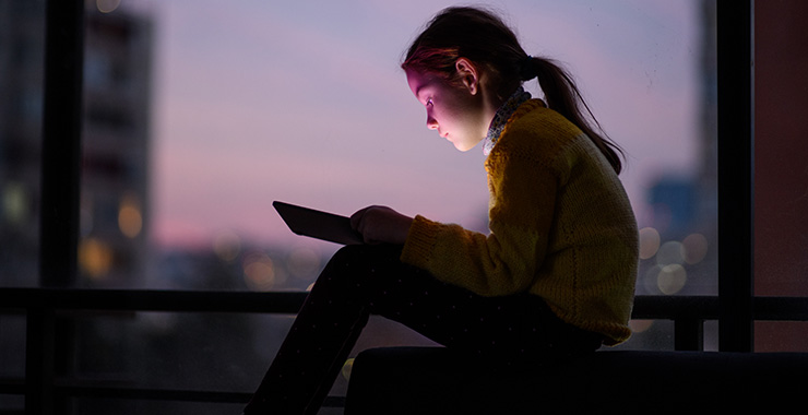 young girl looking at a smart device