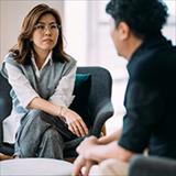 two people sitting and talking