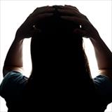 back view of a woman with her hands on her head