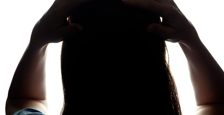 back view of a woman with her hands on her head