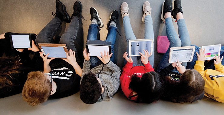 group of students using smart tablets