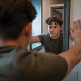 boy looking in the mirror at himself