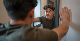 boy looking in the mirror at himself