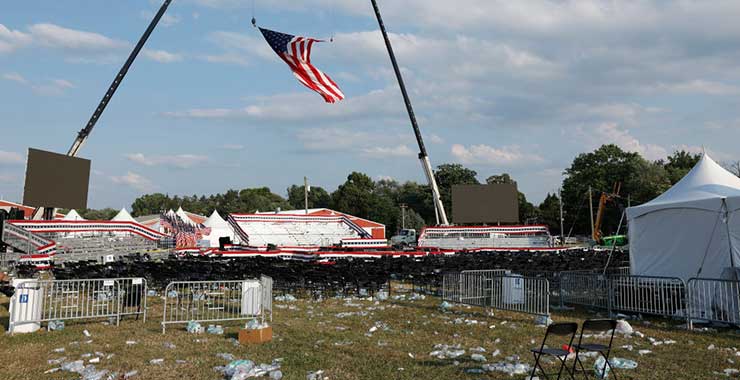 american flag hanging over the empty site of a political rally