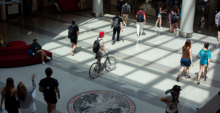 college students walking through an academic building lobby