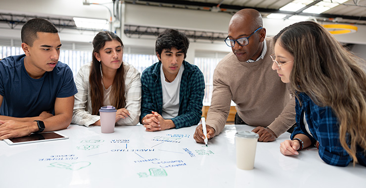 teacher surrounded by teen students