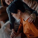 woman comforting another woman