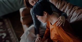 woman comforting another woman