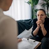 professional with a clipboard having a conversation with another person