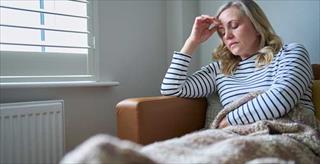 woman on a couch looking tired and distressed