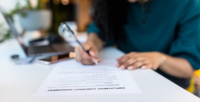 woman signing a contract