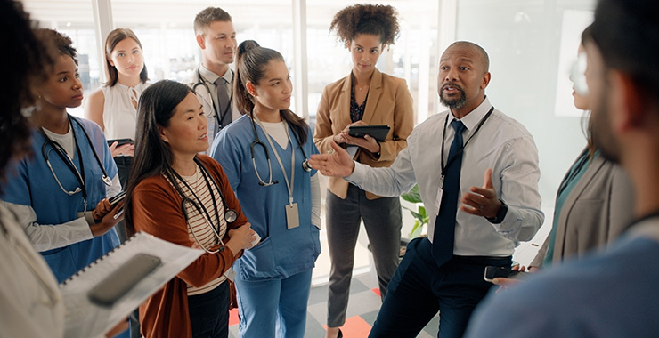 Transplant psychologist talks to a team of medical professionals