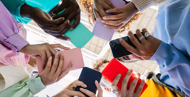 group of hands holding cell phones