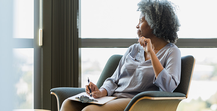 woman sitting with a clipboard
