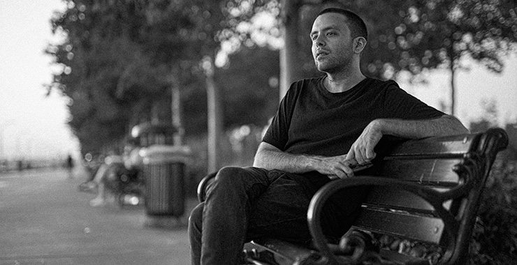 man sitting on a park bench looking thoughtful