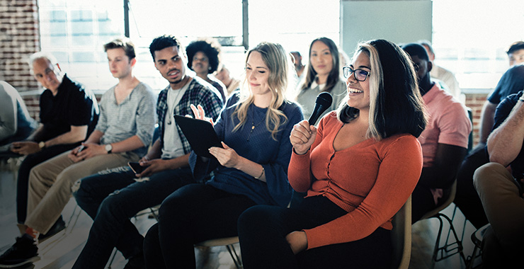audience with a participant holding a microphone
