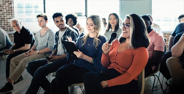 audience with a participant holding a microphone