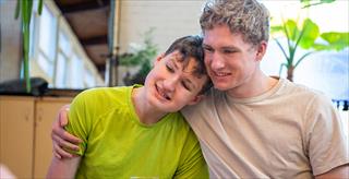 man with arm around child