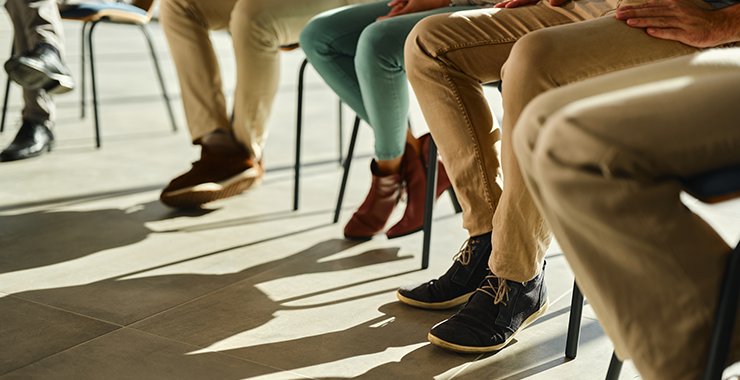 view of several peoples' feet under classroom desks