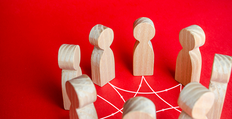 wooden figures connected by string