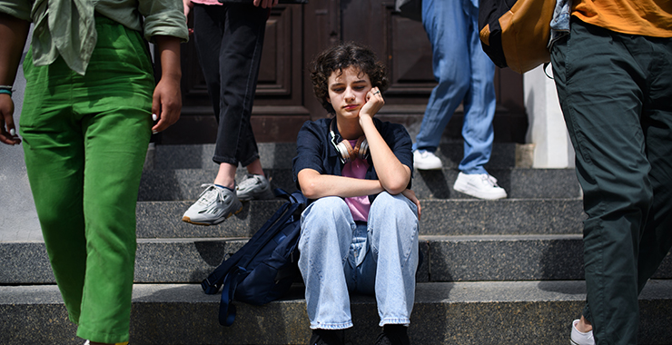 young woman sitting on steps of a building