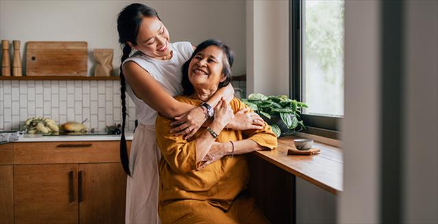 young woman with arms around older woman
