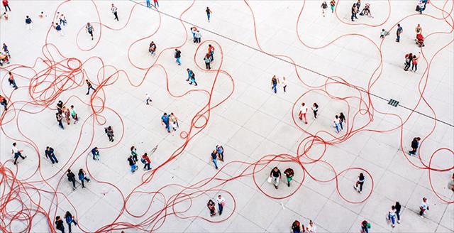 graphic depicting people walking around with string wound through the crowd