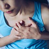 woman with hands over her chest