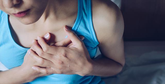 woman with hands over her chest