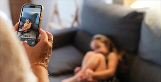 parent taking a picture of a child using a smartphone