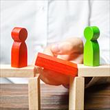 wooden figurines on either side of a block