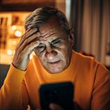 man looking at phone looking concerned
