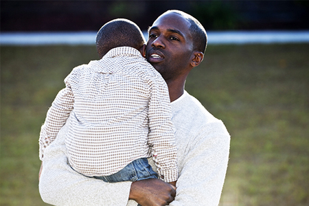 father holding child
