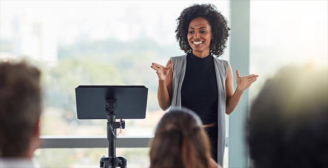 Black woman speaking before an audience