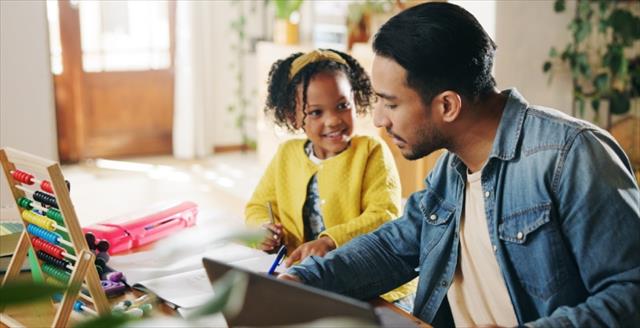 father and daughter doing schoolwork