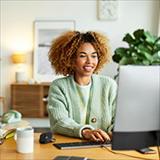 A youn woman looking at her computer