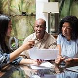 An older couple looking at a paper