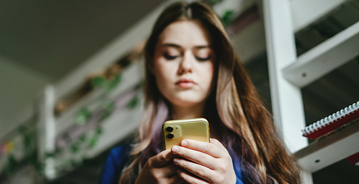 Teenage girl looking at smartphone.