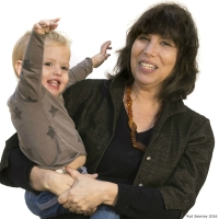 Speaker of Psychology's Alison Gopnik, PhD, holding a toddler.