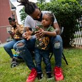 mother and father outside with child