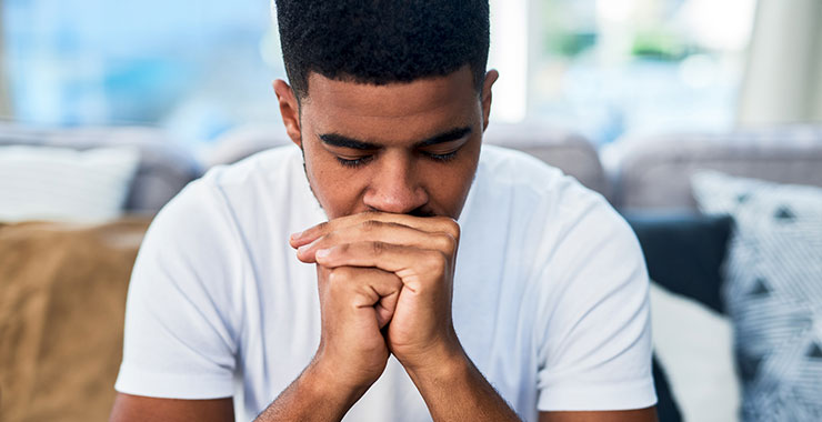 young man looking anxious at home