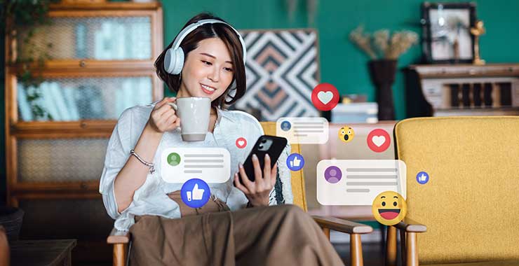woman relaxing in her office and looking at her smartphone