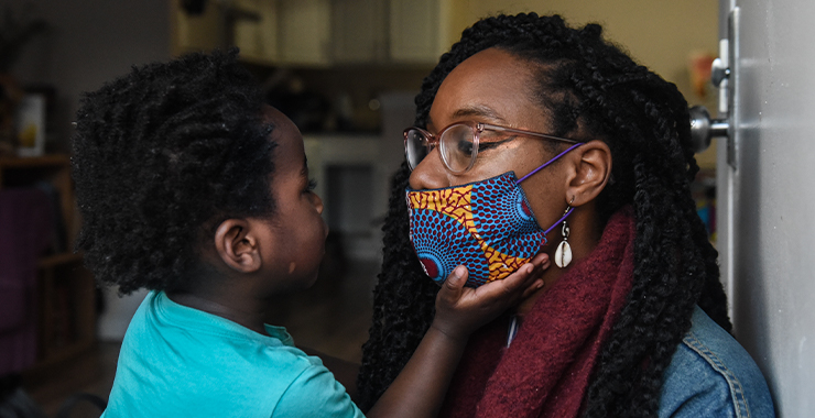 Mother wearing face mask hold toddler