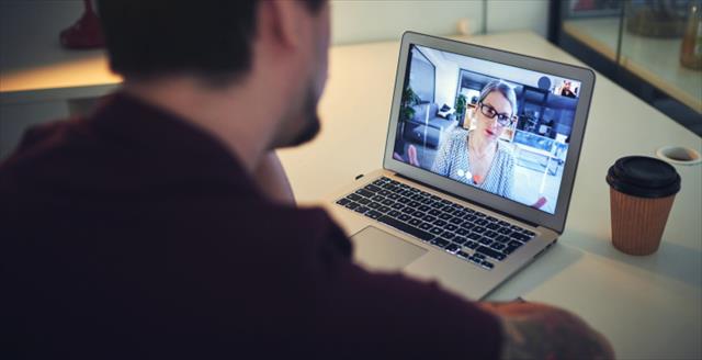 Man looking at a presentation on his computer screen