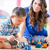 child with down syndrome plays with toys while woman watches