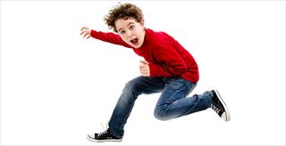 still shot of a boy jumping in the air on a white background