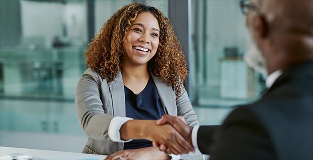 Young Black woman shaking hands as in interview