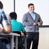 Teacher smiling with students in a classroom