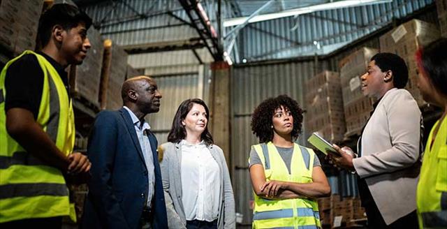 coworkers in a meeting in a warehouse